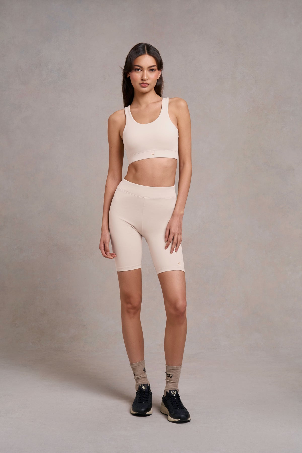 Woman in a rose sports bra and matching cycling shorts