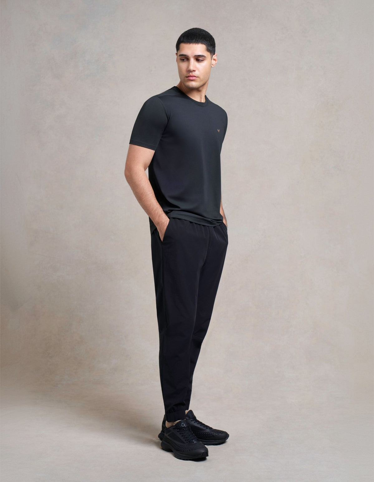 Man in a black tee and black joggers