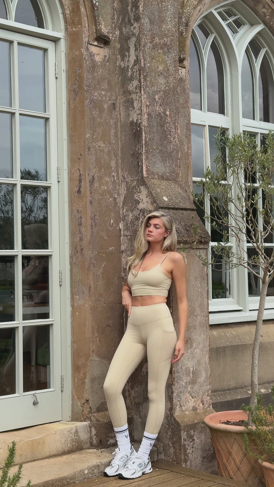 Barley sports bra shown in a mirror selfie and posed indoors and out
